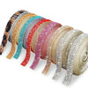 A collection of self-adhesive crystal rhinestone ribbon in various colors, laid out for DIY crafts.