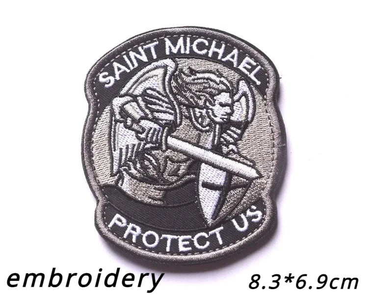 Black embroidered patch featuring Saint Michael with a sword and the text Protect Us