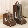 Two brown boot storage bags with clear windows and carry handles resting on a white rug.
