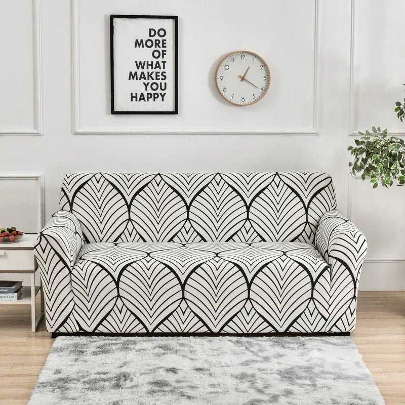 A black and white geometric pattern sofa cover protector displayed on a light gray rug.