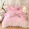 A pink princess chiffon duvet cover set displayed on a bed with sheer white curtains and decorative pillows.
