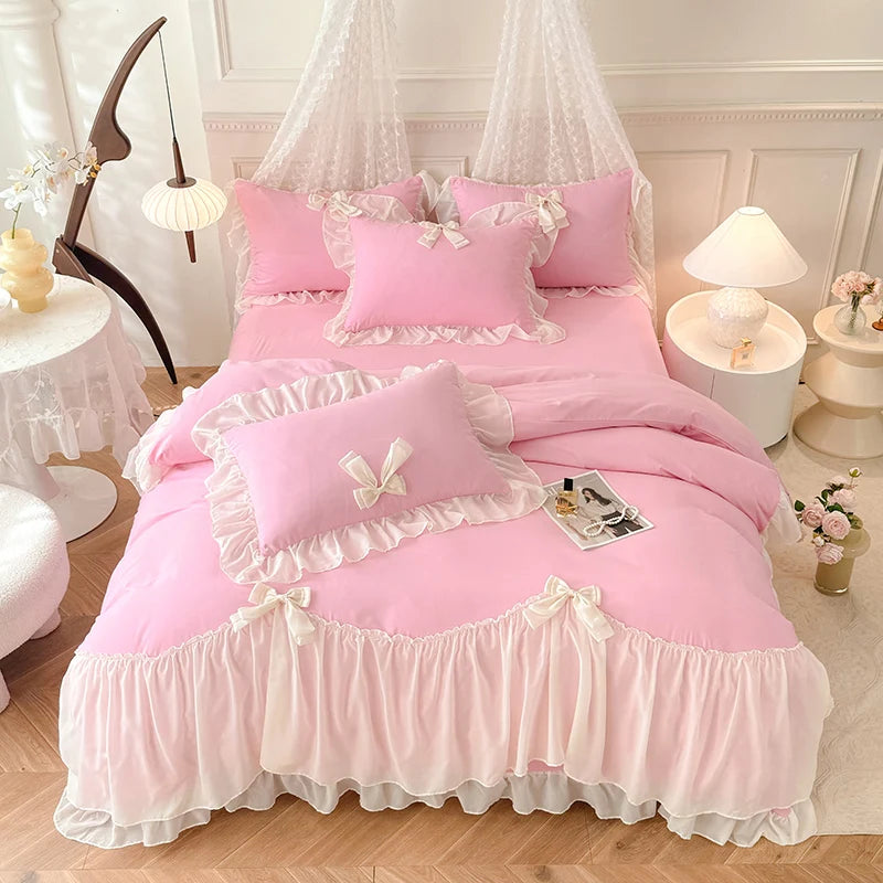 A pink princess chiffon duvet cover set displayed on a bed with sheer white curtains and decorative pillows.