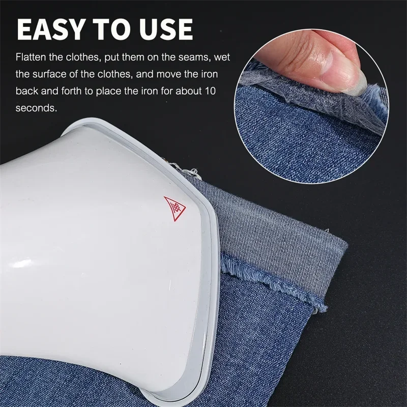 A close-up of a white iron-on adhesive tape being used to flatten and set wrinkles on denim fabric.