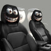 Two black decorative smiley face car pillow covers displayed on a black car seat.