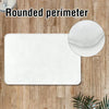 White rounded perimeter non-slip entryway rug on a wooden floor.