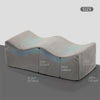 A beige ergonomic memory foam leg support pillow shown from the side with dimensions labeled.