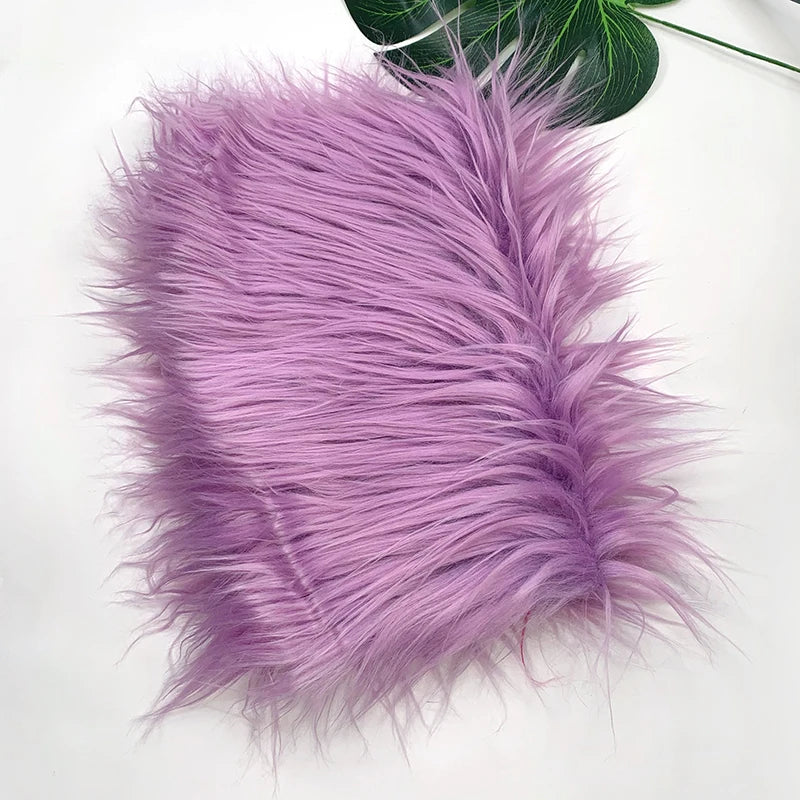 A fluffy purple faux fur fabric used for sewing and crafting.