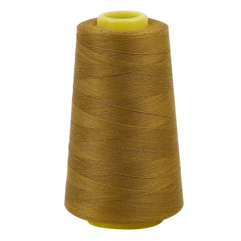A roll of golden brown sewing thread on a yellow spool.