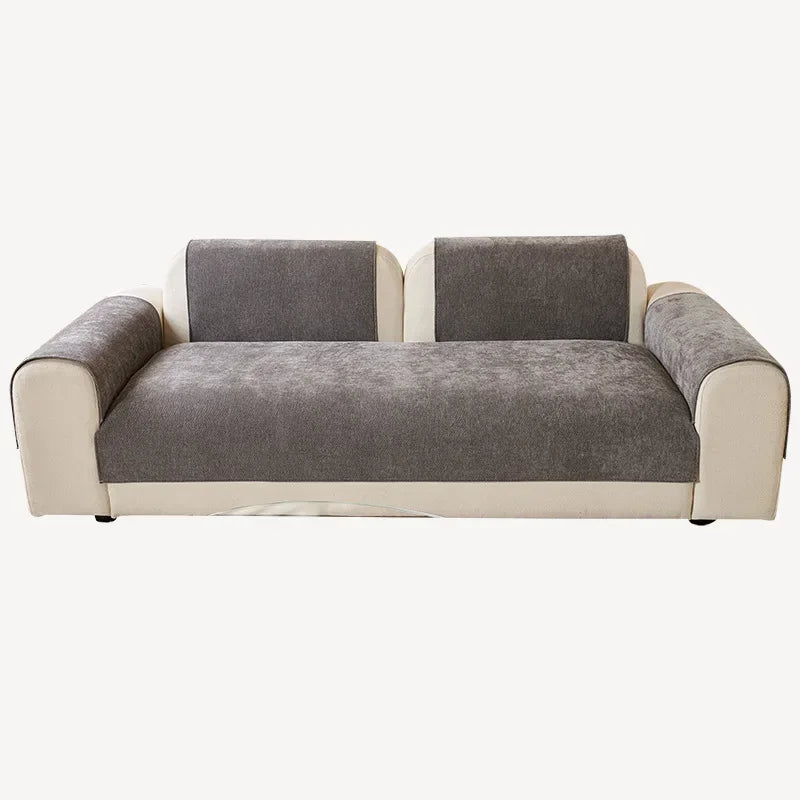 A modern sofa featuring light beige trim and charcoal gray chenille cushions.