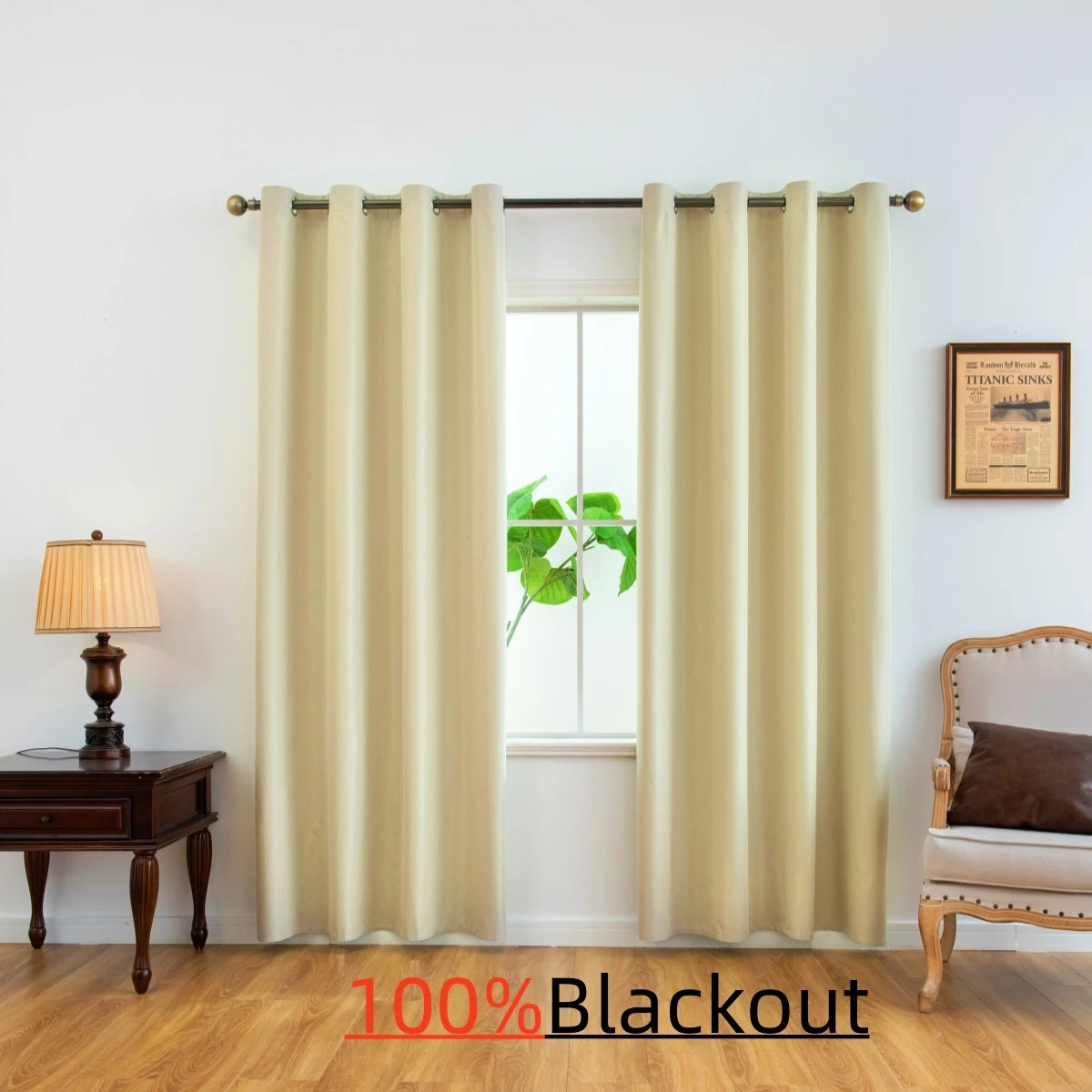 Cream blackout curtains hanging in a window with wooden furniture and a plant visible.