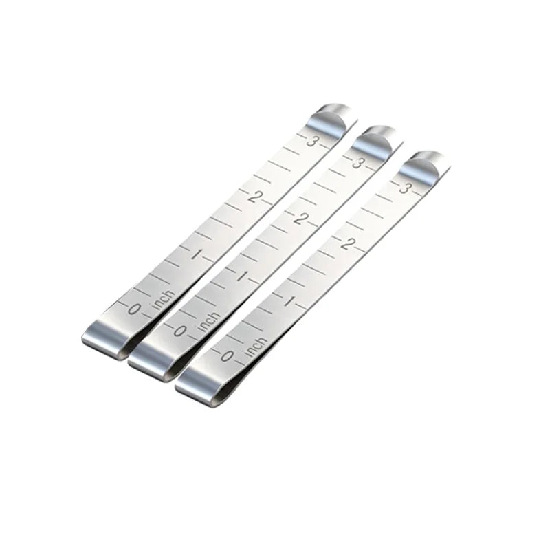 A set of stainless steel sewing hemming clips showing measurement markings.