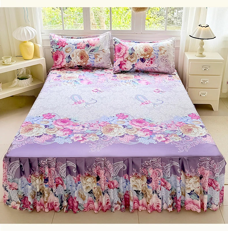 A purple and pink floral print bed skirt set featuring a layered fabric design.