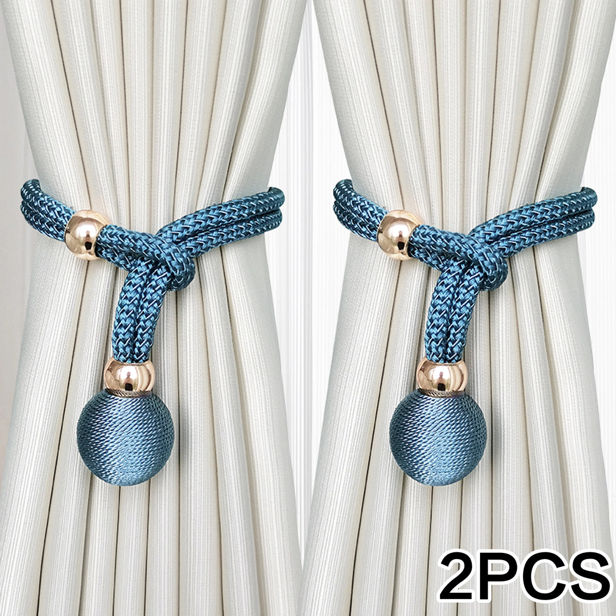 Two pairs of blue fabric tiebacks with gold accents used to secure light beige curtains.