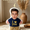 A custom photo face pillow with a male face printed on it, resting on a cream rug.