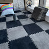 A dark gray and white checkered play mat with a colorful pillow, a globe, and a decorative sailboat in the background.