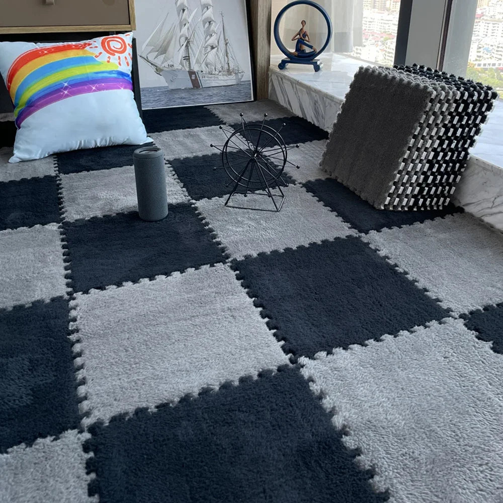 A dark gray and white checkered play mat with a colorful pillow, a globe, and a decorative sailboat in the background.