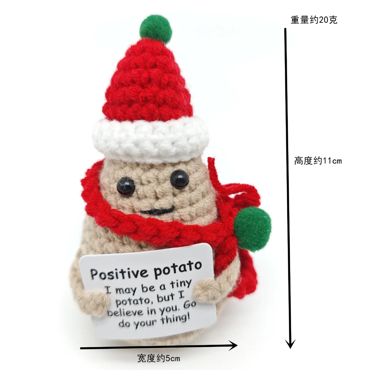 A handmade plush potato doll wearing a red knitted hat and scarf with a positive message tag.