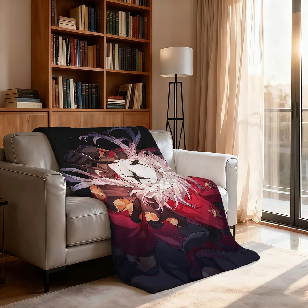 A soft throw blanket featuring a circus theme design draped over a light-colored leather armchair.