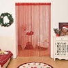 Red beaded string curtains hanging in a doorway, used for home or party decor.