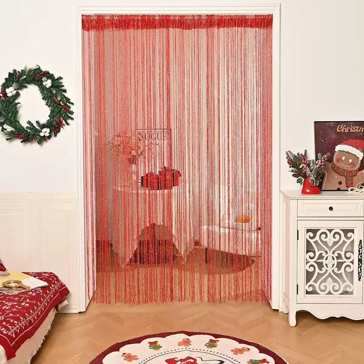 Red beaded string curtains hanging in a doorway, used for home or party decor.