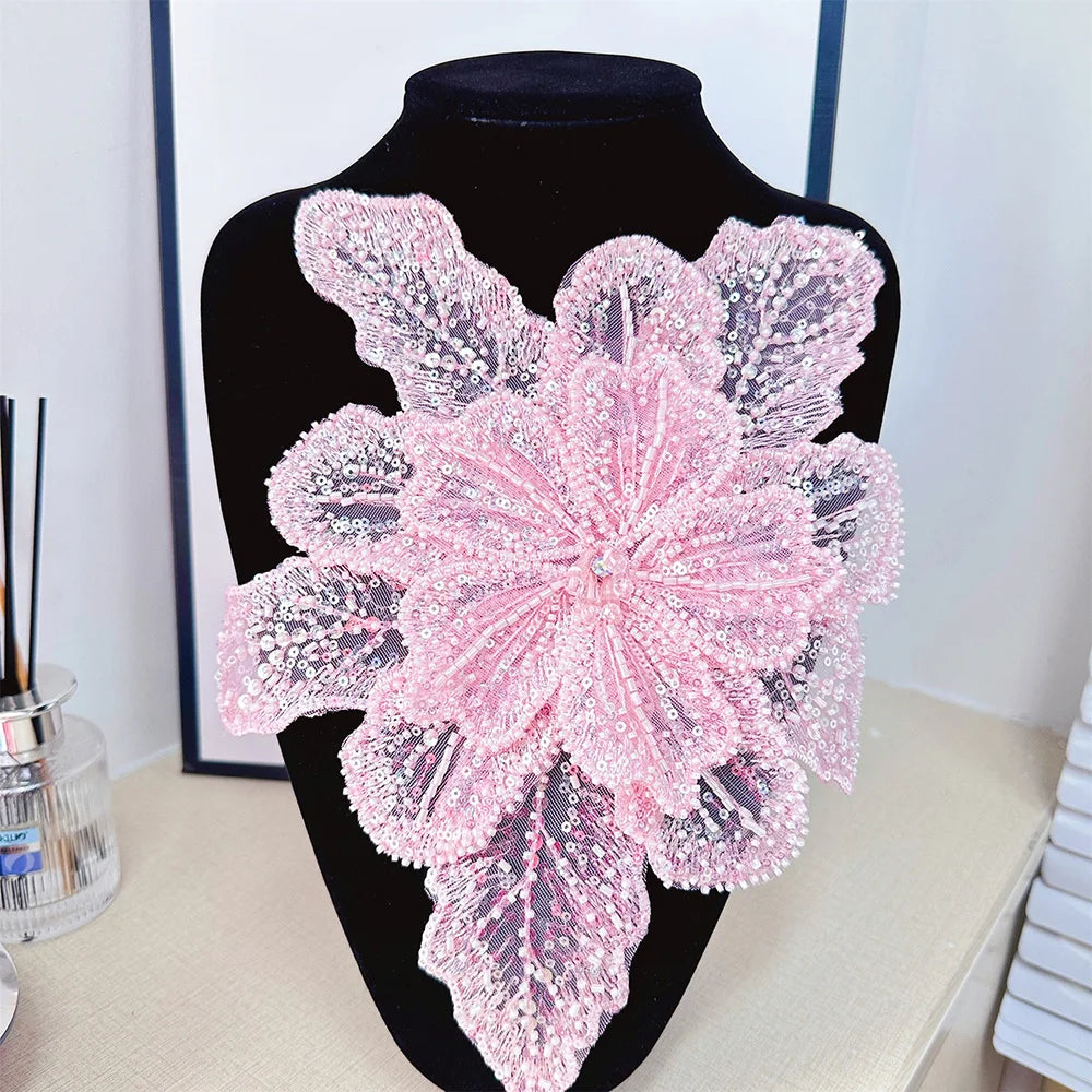 Pink 3D floral sequin lace applique fabric patches displayed on a black mannequin.
