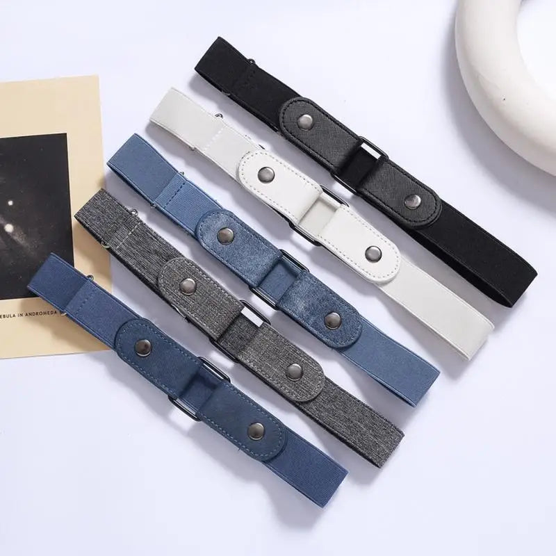 A collection of five invisible stretch belts in black, gray, blue, and white leather for pants and dresses.