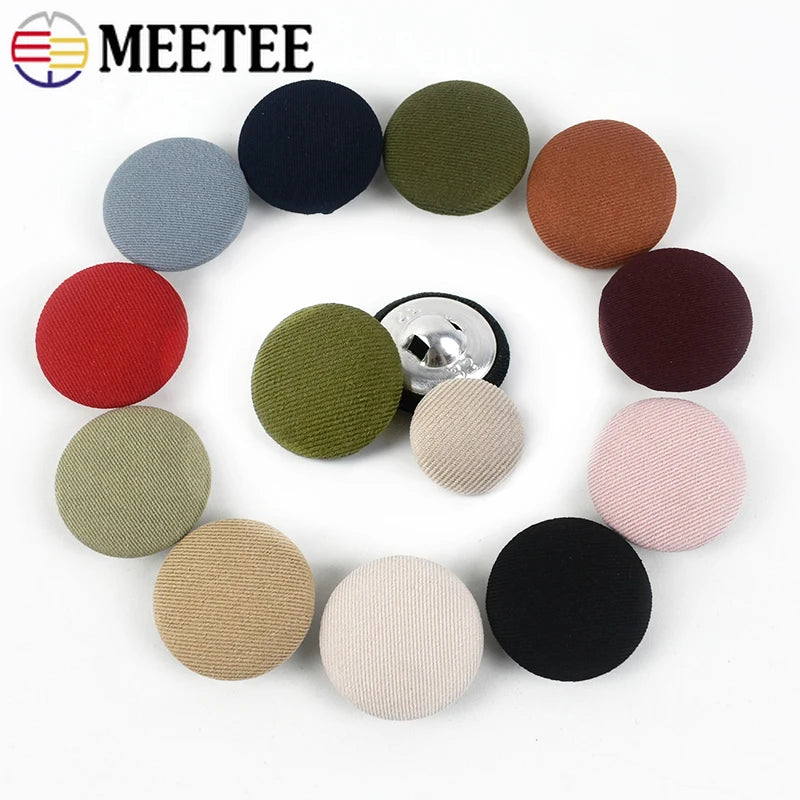 A set of round fabric-covered shank buttons in various colors including black, olive green, terracotta, and pink.