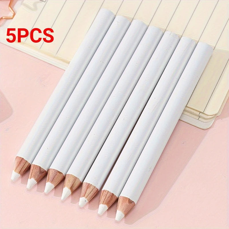 Five white bamboo chalk pencils with wooden tips arranged diagonally on a light pink surface.
