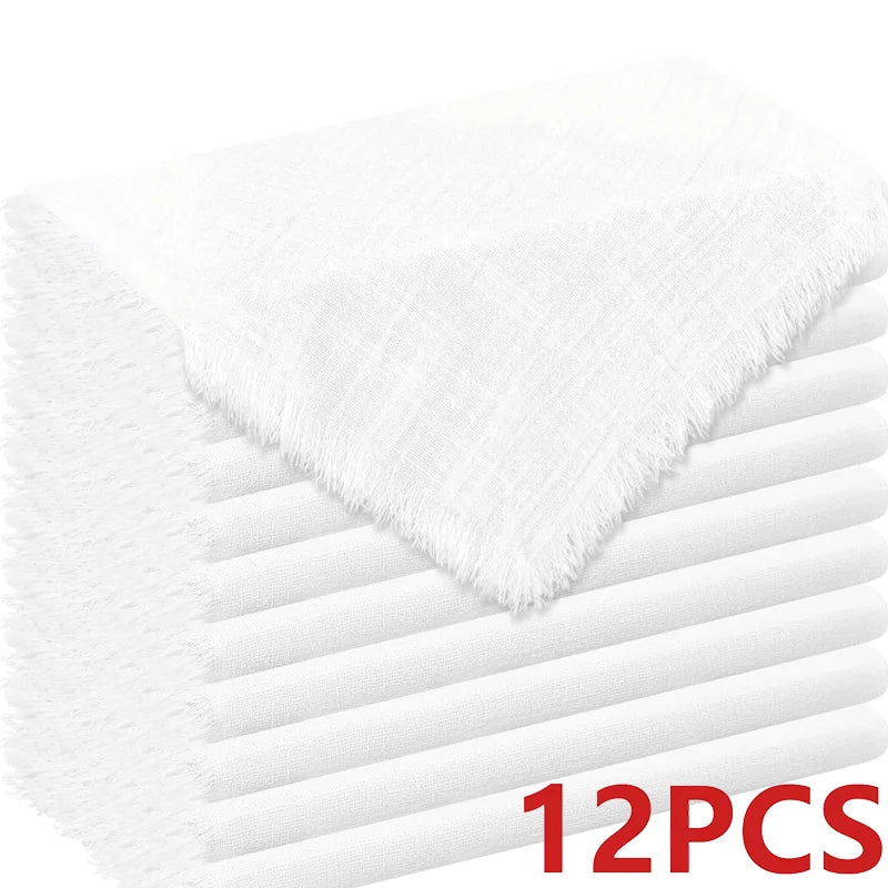 A stack of white decorative cloth napkins, showing the texture and folds.