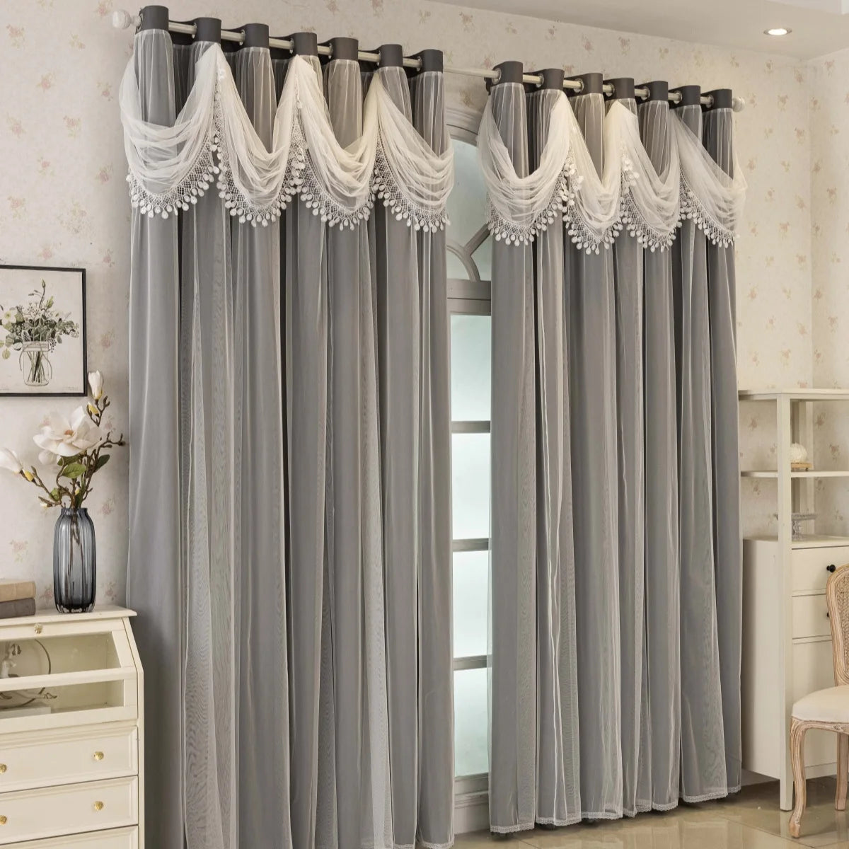 Gray blackout curtains with decorative wave pattern details hanging in a doorway.