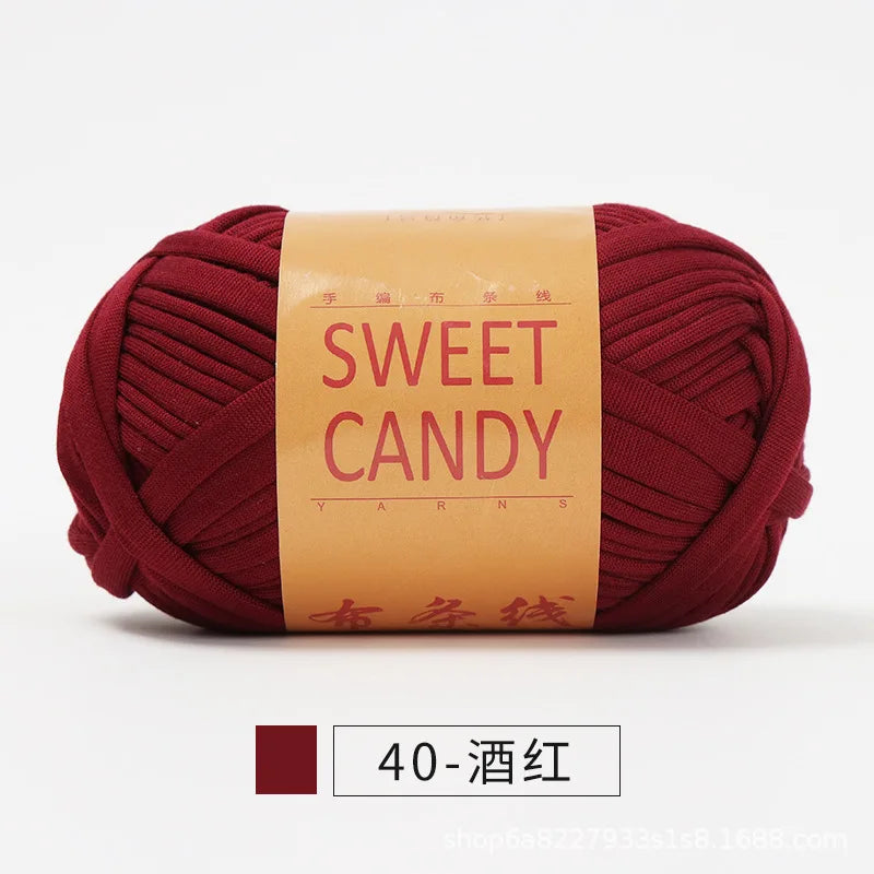 A ball of deep red hand-dyed yarn labeled Sweet Candy with Chinese characters.
