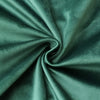 A close-up of a teal velvet throw pillow cover fabric tightly rolled into a swirl.