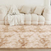 A fluffy cream tie-dye shaggy rug placed on a wooden floor in a bright living room setting.