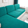 Teal jacquard sofa cushion covers featuring a leaf pattern on a modern sofa.