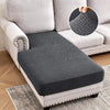 A gray jacquard stretch sofa cushion cover placed on a light-colored sofa, with an inset showing the woven texture.