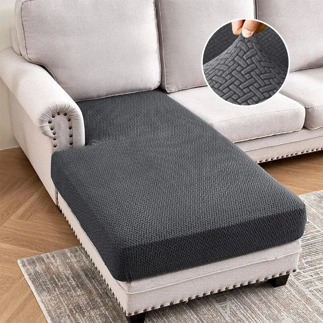 A gray jacquard stretch sofa cushion cover placed on a light-colored sofa, with an inset showing the woven texture.