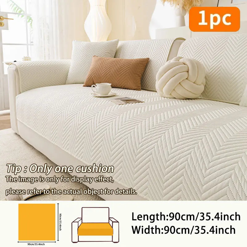 A cream and beige anti-slip fabric sofa cushion cover with decorative pillows shown on a light-colored sofa.