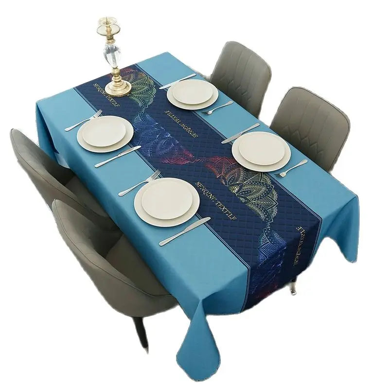 A blue rectangular waterproof tablecloth set for dining or party decor with place settings and a candlestick.