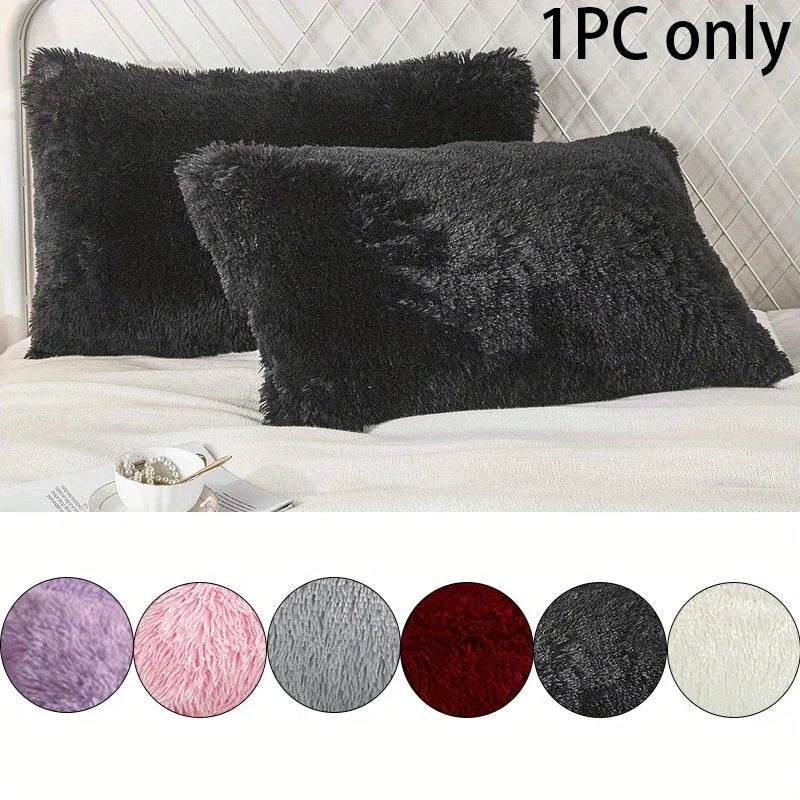A collection of nine round faux fur pillow covers in various shades including purple pink gray and black displayed on a white