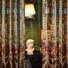 Neoclassical sheer curtains with floral embroidery draped in a richly textured teal fabric.