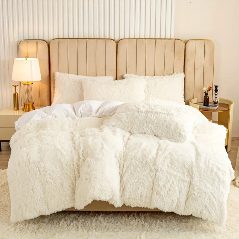 A luxurious white plush duvet cover set displayed on a bed with upholstered headboards and a light rug.