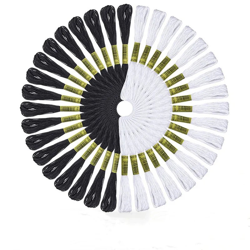 A circular set of embroidery floss with black and white threads arranged in a fan pattern.