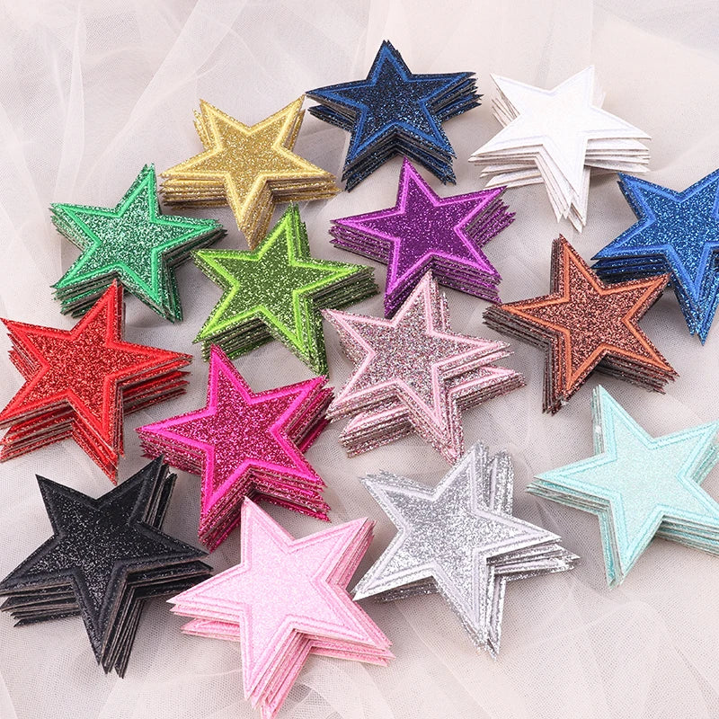 A collection of five glitter star-shaped iron-on patches in various colors including gold, green, purple, silver, and blue.