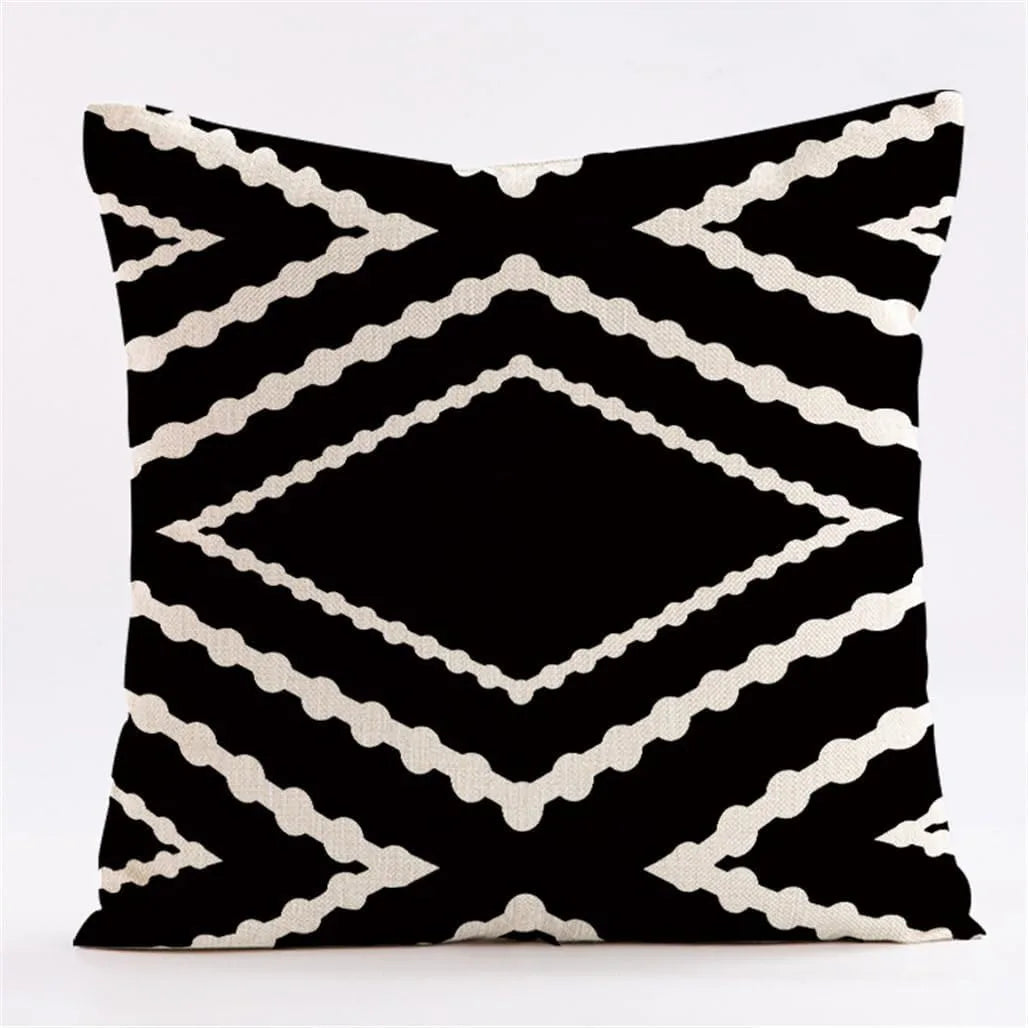 Geometric black and white throw pillow covers featuring a repeating diamond pattern