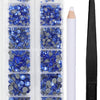 A clear plastic case containing various blue and gray crystal rhinestones and an applicator tool.