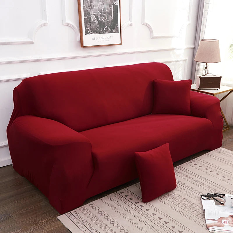 A deep red elegant faux silk sofa cover displayed on a light-colored rug in a well-lit room.