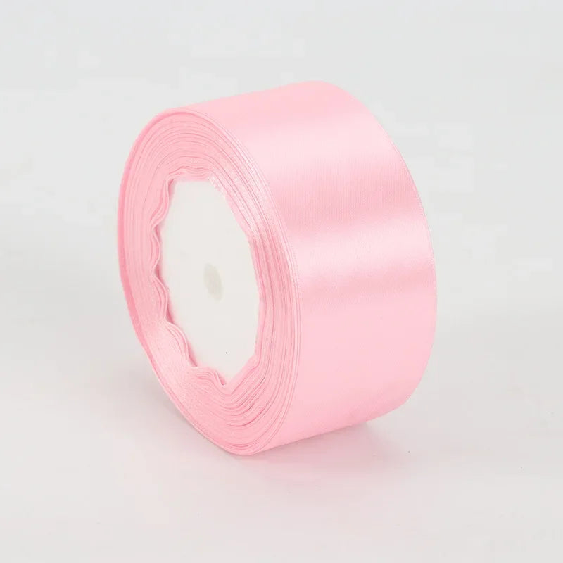 A roll of pink satin ribbon measuring 4cm for crafts and gift wrapping.