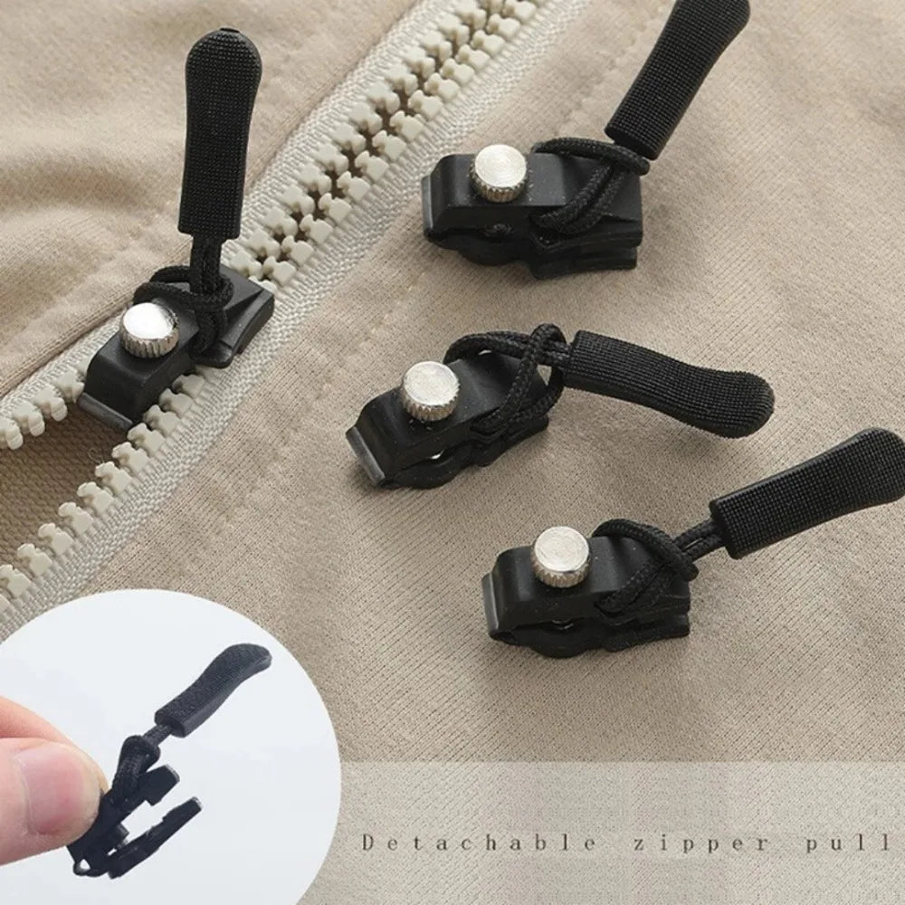 Black detachable zipper pull kit with replacement heads shown on a beige fabric background.