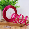 Roll of bright pink satin ribbon for crafting or decoration