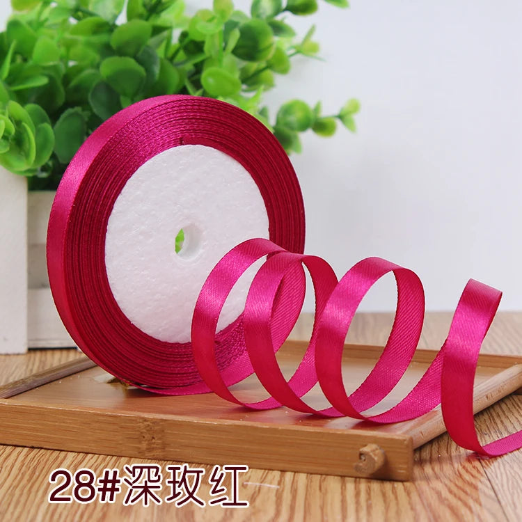 Roll of bright pink satin ribbon for crafting or decoration